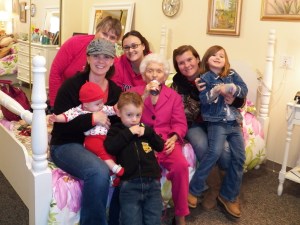 Mom is drinking her Boost while the family gathers around.