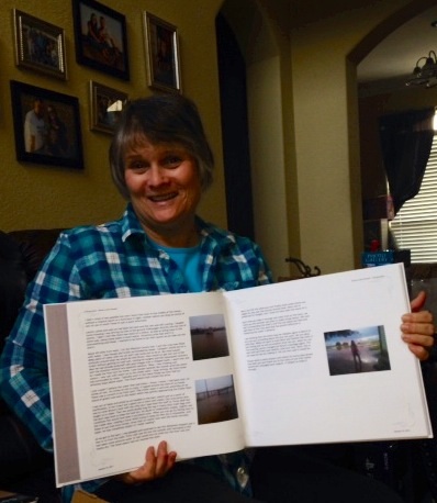 Holding the book of my blog of Bruno's first 300 days.