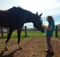 Jordyn feeding Bruno wild flowers.
