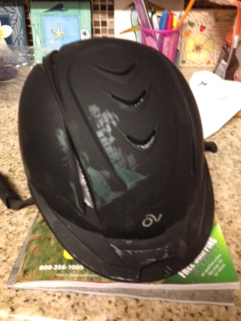 The skid marks from a a big green jump standard on Jordyn's helmet.